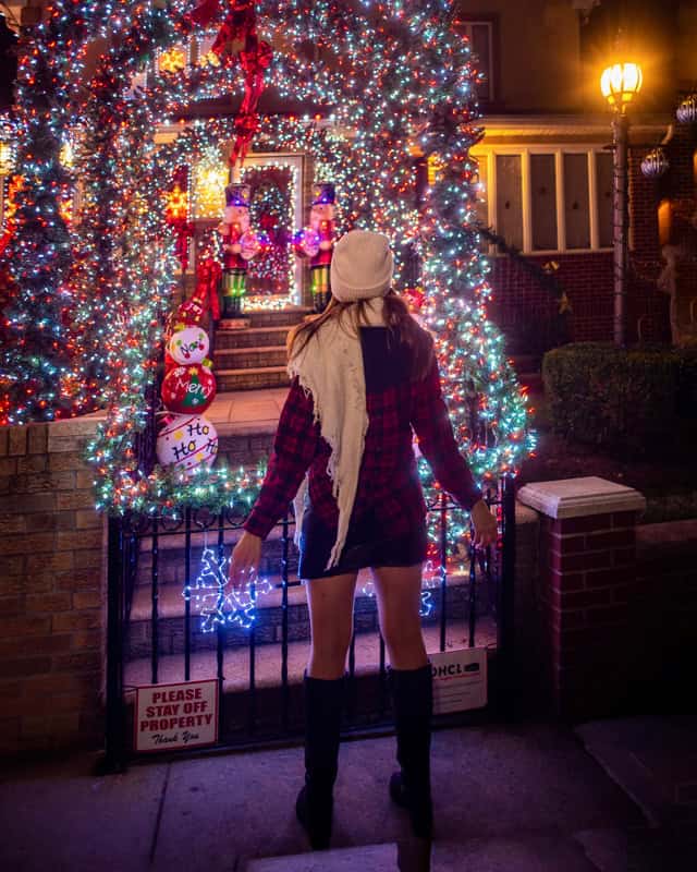 Laura in front of Dyker Heights Christmas lights display Brooklyn NYC December