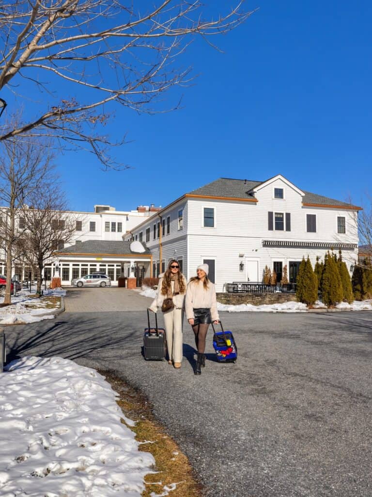 Laura and her friend leaving a boutique hotel in Manchester Vermont after a winter weekend getaway