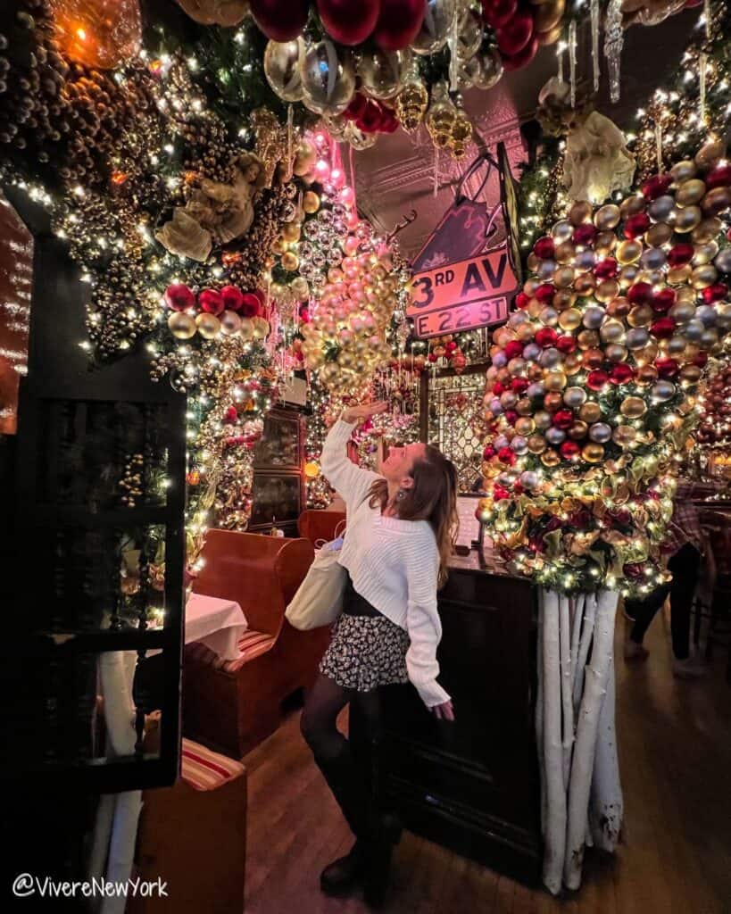 Laura at Rolf's German restaurant Gramercy NYC Christmas ornament ceiling holiday decor