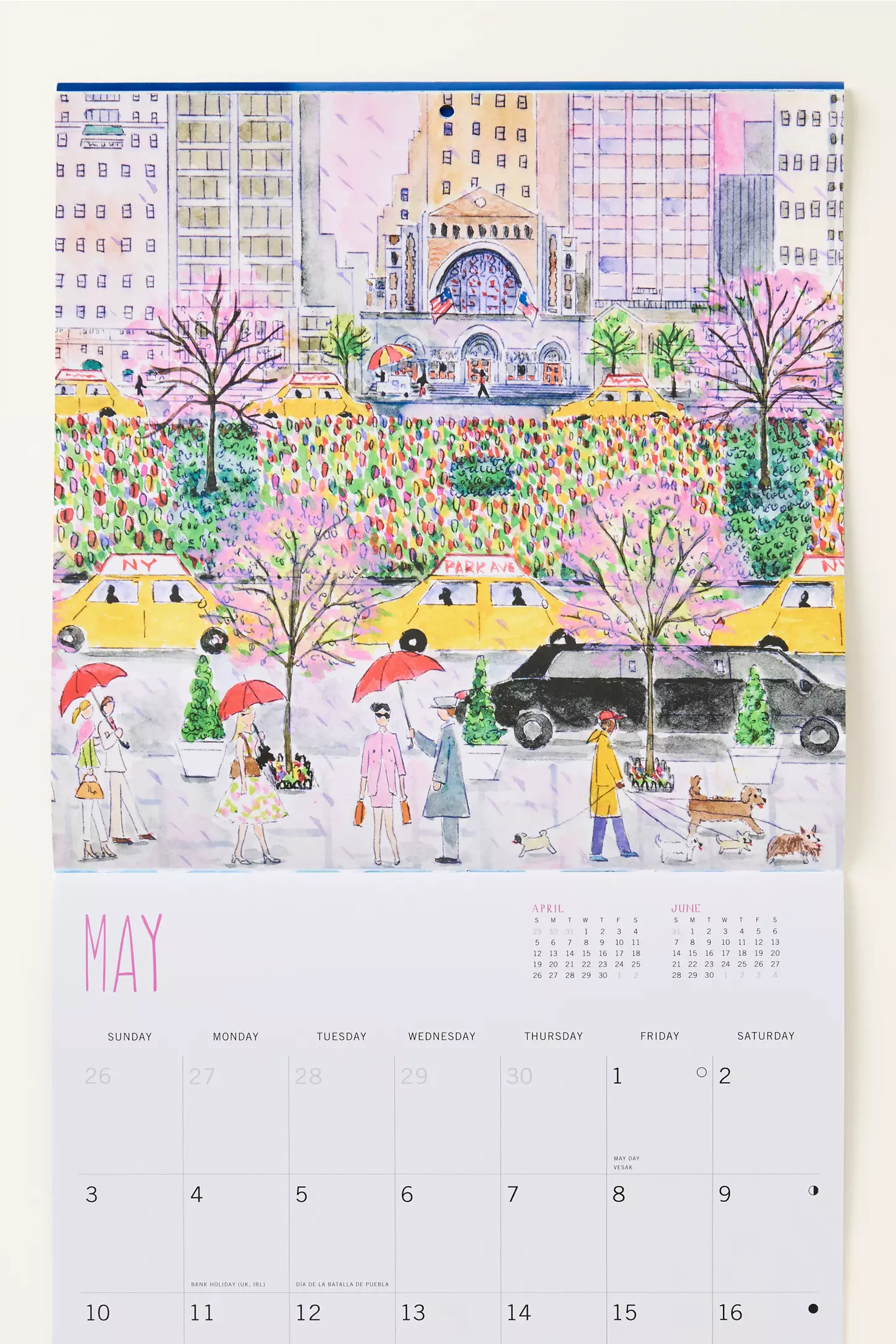 Illustrated 2026 NYC wall calendar with colorful city scenes, yellow taxis, and whimsical New York details by artist Michael Storring