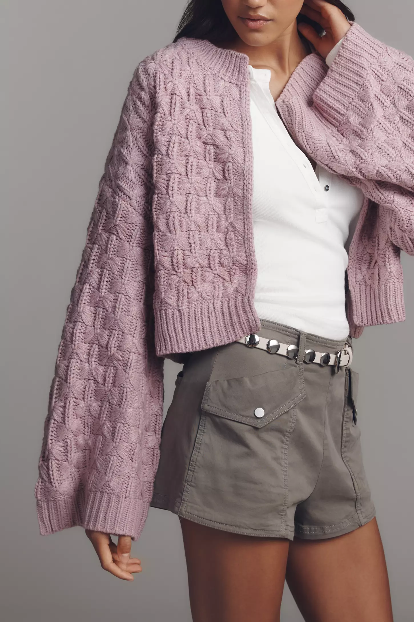 Lilac cropped cable-knit cardigan sweater with oversized sleeves styled with white top and shorts