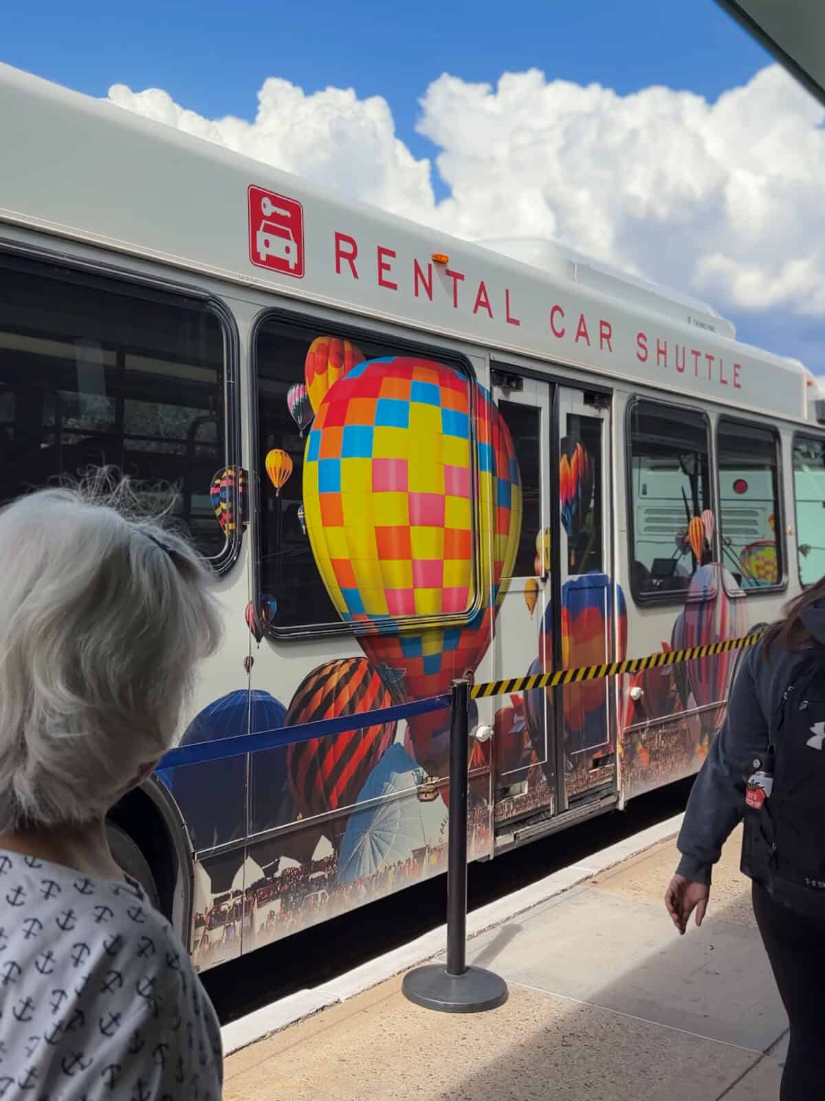 Rental car shuttle wrapped in colorful hot air balloon artwork at the Albuquerque airport, the start of a New Mexico itinerary