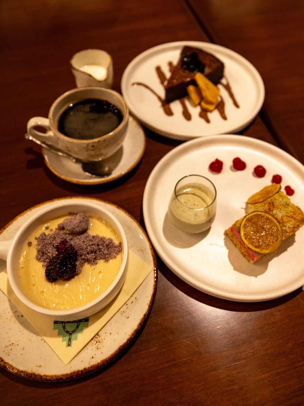 Blue corn streusel panna cotta, prickly pear lime cake and dark chocolate torte plated at the Corn Maiden restaurant