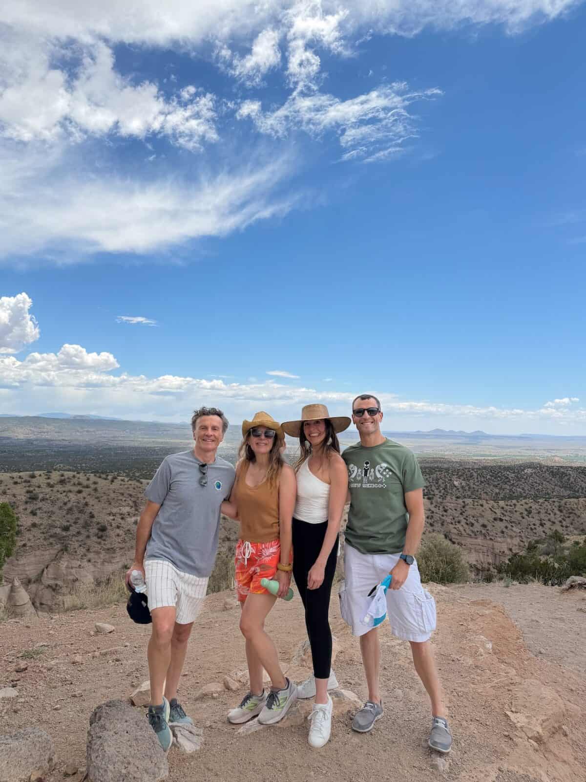 Laura and Luca with family at the Tent Rocks overlook, the Rio Grande valley stretching out behind them