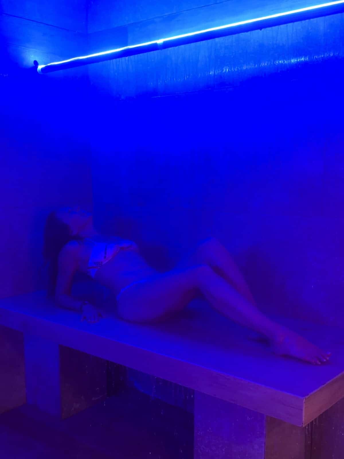 Laura relaxing under a Vichy shower at QC NY Spa on Governors Island
