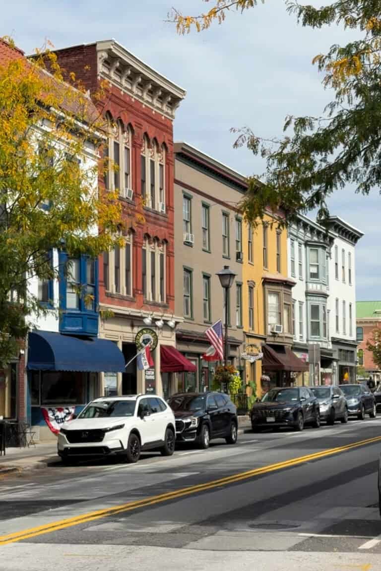 Colorful historic brick buildings, independent storefronts, and tree-lined streets in downtown Gettysburg, Pennsylvania, during early fall.